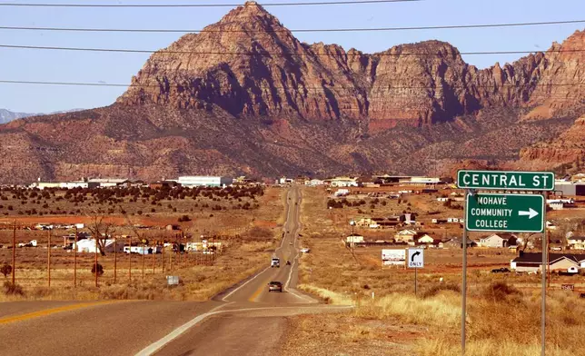 FILE - The twin towns of Colorado City, Ariz., and Hildale, Utah, are surrounded by a backdrop of the Vermillion Cliffs, Thursday, Jan. 15, 2004. The polygamist town was originally known as Short Creek, but residents later changed the name after an infamous 1953 raid by Arizona officials who hauled polygamist men away and sent more than 200 children to foster homes. (AP Photo/Joe Cavaretta, File)