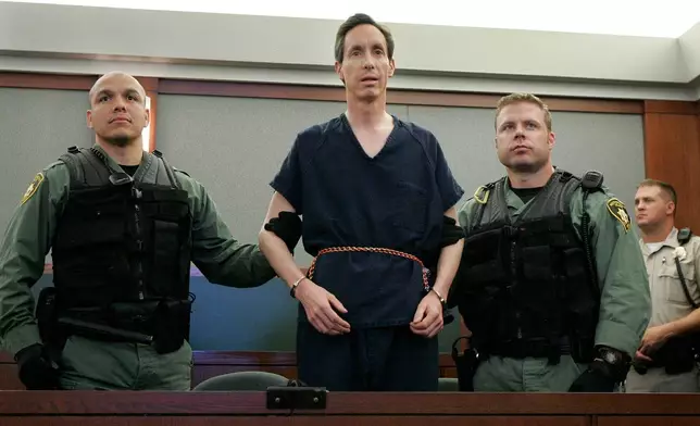 FILE - Polygamous church leader Warren Jeffs appears in a courtroom surrounded by guards in Las Vegas, on Aug. 31, 2006. (AP Photo/Laura Rauch, File)