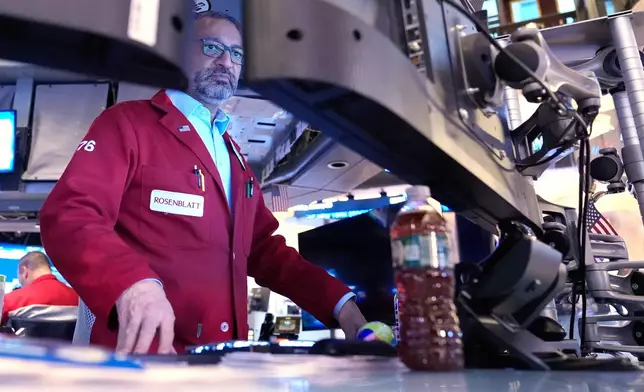 Aman Patel works on the floor at the New York Stock Exchange in New York, Friday, Jan. 9, 2026. (AP Photo/Seth Wenig)