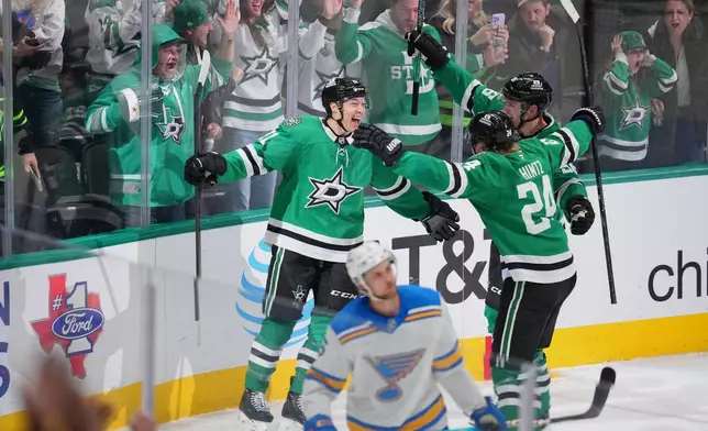 Dallas Stars left wing Jason Robertson, left, celebrates his third period goal with center Roope Hintz (24) and right wing Mikko Rantanen (96) during an NHL hockey game against the St. Louis Blues Friday, Jan. 23, 2026, in Dallas. (AP Photo/Julio Cortez)