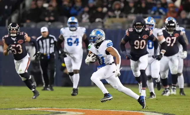 Detroit Lions wide receiver Kalif Raymond (11) runs up field after catching a pass during the second half of an NFL football game against the Chicago Bears, Sunday, Jan. 4, 2026, in Chicago. (AP Photo/Nam Y. Huh)