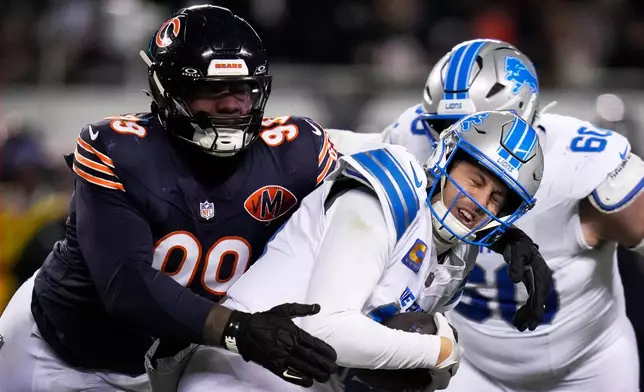 Detroit Lions quarterback Jared Goff is sacked by Chicago Bears defensive tackle Gervon Dexter Sr. (99) during the second half of an NFL football game, Sunday, Jan. 4, 2026, in Chicago. (AP Photo/Erin Hooley)