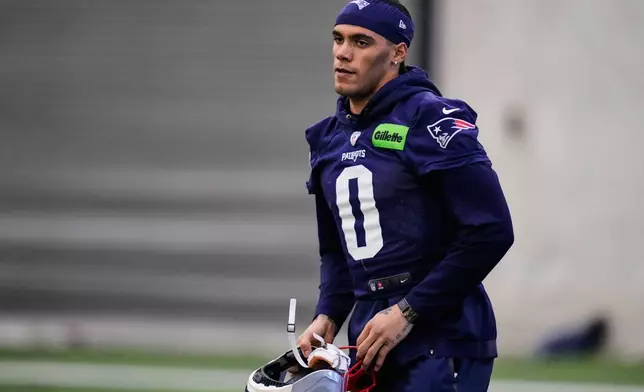 New England Patriots cornerback Christian Gonzalez (0) stretches during an NFL football availability, Thursday, Jan. 29, 2026, in Foxborough, Mass. (AP Photo/Charles Krupa)