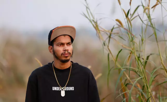 Mohan Miajee, 29, who escaped after fighting for the Russian army, poses for a portrait in Munshiganj, Bangladesh, Dec. 9, 2025. (AP Photo/Rajib Dhar)