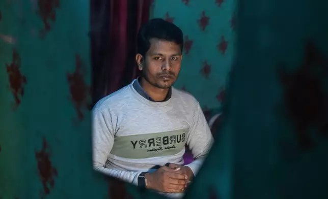 Maksudur Rahman, 31, who escaped after fighting for the Russian army, poses during an interview with the Associated Press in Lakshmipur, Bangladesh, Dec. 10, 2025. (AP Photo/Rajib Dhar)