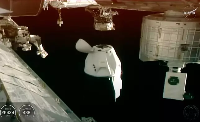 This screengrab from video provided by NASA TV shows the SpaceX Dragon departing from the International Space Station shortly after undocking with four NASA Crew-11 members inside on Wednesday, Jan. 14, 2026. (NASA via AP)