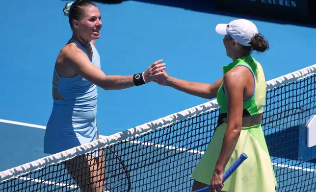 Madison Keys, right, of the U.S. is congratulated by Oleksandra Oliynykova of Ukraine following their first round match at the Australian Open tennis championship in Melbourne, Australia, Tuesday, Jan. 20, 2026. (AP Photo/Asanka Brendon Ratnayake)