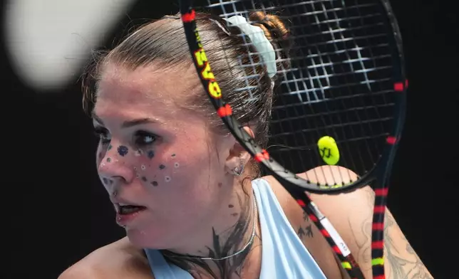 Oleksandra Oliynykova of Ukraine plays a backhand return to Madison Keys of the U.S. during their first round match at the Australian Open tennis championship in Melbourne, Australia, Tuesday, Jan. 20, 2026. (AP Photo/Asanka Brendon Ratnayake)