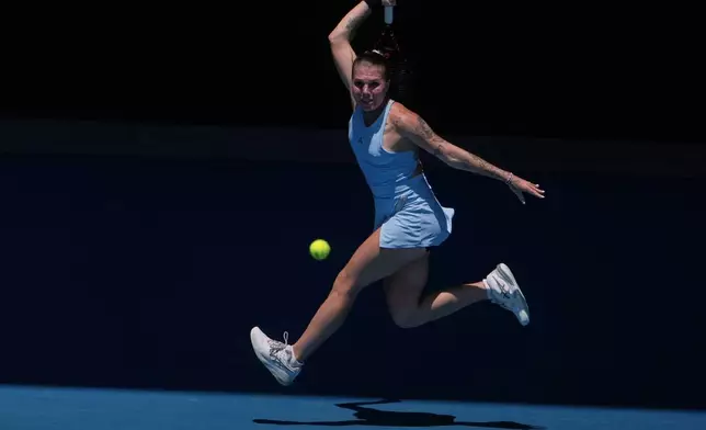 Oleksandra Oliynykova of Ukraine plays a forehand return to Madison Keys of the U.S. during their first round match at the Australian Open tennis championship in Melbourne, Australia, Tuesday, Jan. 20, 2026. (AP Photo/Asanka Brendon Ratnayake)