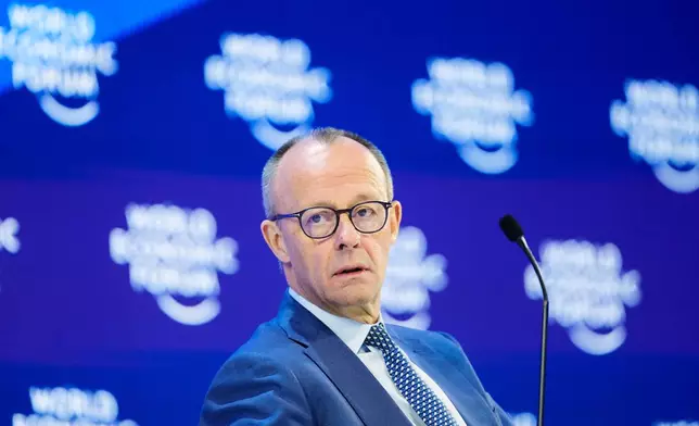 German Chancellor Friedrich Merz sits on the podium during the Annual Meeting of the World Economic Forum in Davos, Switzerland, Thursday, Jan. 22, 2026. (AP Photo/Markus Schreiber)