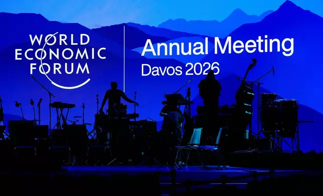 People set up the instruments for the opening concert of the Annnual Meeting of the World Economy Forum at the Congress Center in Davos, Switzerland, Sunday, Jan. 18, 2026. (AP Photo/Markus Schreiber)