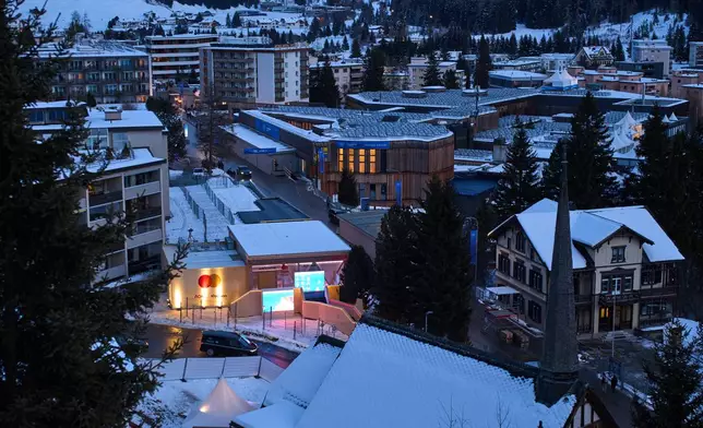 The windows of the Congress Center, center top, where the Annual Meeting of the World Economy Forum take place are illuminated in Davos, Switzerland, Saturday, Jan. 17, 2026. (AP Photo/Markus Schreiber)