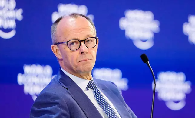 German Chancellor Friedrich Merz sits on the podium during the Annual Meeting of the World Economic Forum in Davos, Switzerland, Thursday, Jan. 22, 2026. (AP Photo/Markus Schreiber)