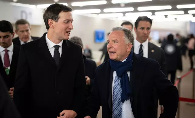 Jared Kushner, left, and Steve Witkoff walk in the corridors during the 56th annual meeting of the World Economic Forum, WEF, in Davos, Switzerland, Tuesday, Jan. 20, 2026. (Gian Ehrenzeller/Keystone via AP)