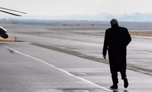 President Donald Trump walks toward Marine One to transfer to Davos after arriving at the airport in Zurich, Switzerland, Wednesday, Jan. 21, 2026. (AP Photo/Evan Vucci)