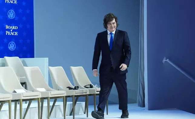 Javier Milei, President of Argentina, arrives for a Board of Peace charter announcement during the Annual Meeting of the World Economic Forum in Davos, Switzerland, Thursday, Jan. 22, 2026. (AP Photo/Evan Vucci)