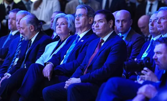 United States Secretary of State Marco Rubio, center, right, sits with U.S. Treasury Secretary Scott Bessent, center, and White House chief of staff Susie Wiles, center left, as they listen to the address of President Donald Trump during the Annual Meeting of the World Economic Forum in Davos, Switzerland, Wednesday, Jan. 21, 2026. (AP Photo/Evan Vucci)