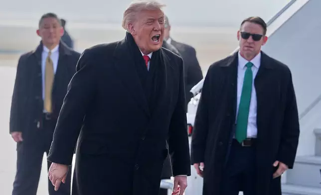 President Donald Trump, center, speaks as he steps off Air Force One after arriving at Zurich International Airport for the World Economic Forum, Wednesday, Jan. 21, 2026, in Zurich, Switzerland. (AP Photo/Evan Vucci)