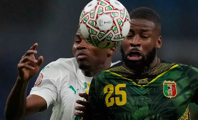 Senegal's Mouhamadou Diallo, left, and Mali's Ousmane Camara fight for the ball during the Africa Cup of Nations quarterfinal soccer match between Senegal and Mali in Tangier, Morocco, Friday, Jan. 9, 2026. (AP Photo/Themba Hadebe)