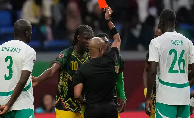 Referee Abongile Tom shows the red card to Mali's Yves Bissouma during the Africa Cup of Nations quarterfinal soccer match between Senegal and Mali in Tangier, Morocco, Friday, Jan. 9, 2026. (AP Photo/Themba Hadebe)