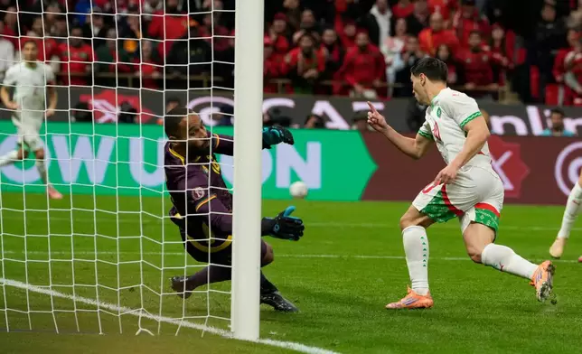 Morocco's Brahim Abdelkader Díaz, right, scores his side's opening goal during the Africa Cup of Nations quarterfinal soccer match between Cameroon and Morocco, in Rabat, Morocco, Friday, Jan. 9, 2026. (AP Photo/Mosa'ab Elshamy)