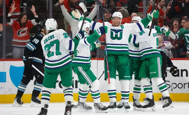 Carolina Hurricanes' Jordan Staal, third from right, celebrates after his winning goal during the third period of an NHL hockey game against the Utah Mammoth in Raleigh, N.C., Thursday, Jan. 29, 2026. (AP Photo/Karl DeBlaker)