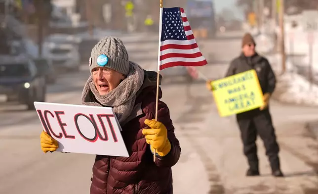 Rosie Grutze protests the presence of the U.S. Immigration and Customs Enforcement, Wednesday, Jan. 21, 2026, in Portland, Maine. (AP Photo/Robert F. Bukaty)