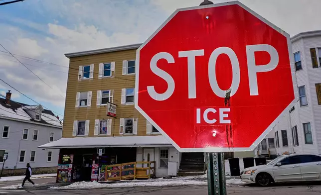 Anti-ICE sentiment is expressed on a traffic sign, Friday, Jan. 23, 2026, in Biddeford, Maine.(AP Photo/Robert F. Bukaty)