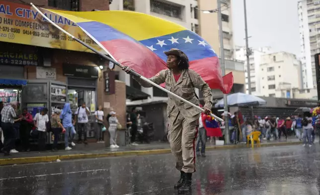 Government supporters rally to mark the anniversary of the 1958 coup that overthrew Venezuelan dictator Marcos Pérez Jiménez in Caracas, Venezuela, Friday, Jan. 23, 2026. (AP Photo/Ariana Cubillos)