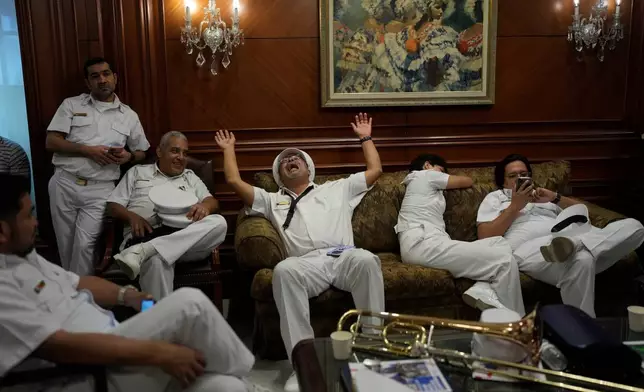 Presidential marching band members wait at the presidential palace to play their instruments during the welcoming ceremony for Brazil's President Luiz Inacio Lula da Silva in Panama City, Wednesday, Jan. 28, 2026. (AP Photo/Matias Delacroix)