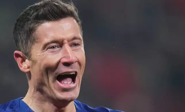 Barcelona's Robert Lewandowski celebrates after scoring his side's fourth goal during the Champions League opening phase soccer match between Slavia Prague and Barcelona in Prague, Czech Republic, Wednesday, Jan. 21, 2026. (AP Photo/Petr David Josek)