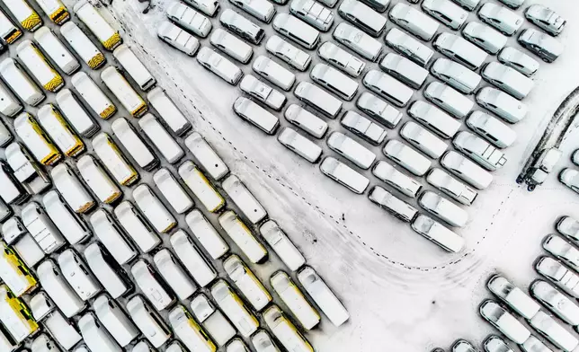 Vehicles covered in snow are parked in Dowlais, near Merthyr Tydfil, Wales, Friday, Jan. 9, 2026, as Storm Goretti continues in the UK. (Ben Birchall/PA via AP)
