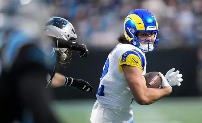 Los Angeles Rams wide receiver Puka Nacua (12) runs after a catch during the first half of an NFL wild-card playoff football game against the Carolina Panthers, Saturday, Jan. 10, 2026, in Charlotte, N.C. (AP Photo/Jacob Kupferman)
