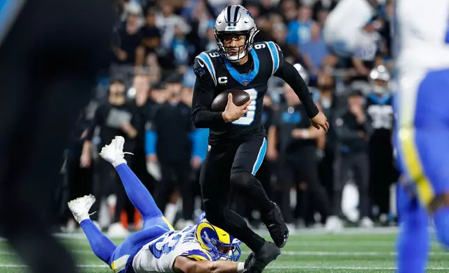 Carolina Panthers quarterback Bryce Young (9) runs for a touchdown during the first half of an NFL wild-card playoff football game against the Los Angeles Rams, Saturday, Jan. 10, 2026, in Charlotte, N.C. (AP Photo/Rusty Jones)