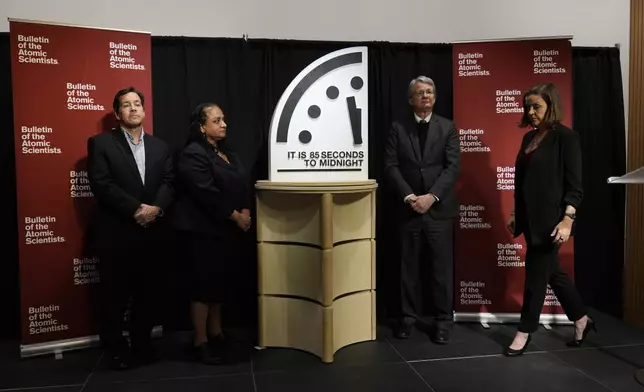 The Bulletin of the Atomic Scientist members, from left, Jon B. Wolfsthal, Asha M. George, Steve Fetter and Alexandra Bell, reveal the Doomsday Clock, set to 85 seconds to midnight, during a news conference at the Carnegie Endowment for International Peace, Friday, Jan. 23, 2026, in Washington. (AP Photo/Pablo Martinez Monsivais)
