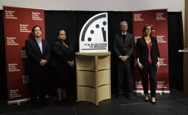 The Bulletin of the Atomic Scientist members, from left, Jon B. Wolfsthal, Asha M. George, Steve Fetter and Alexandra Bell, reveal the Doomsday Clock, set to 85 seconds to midnight, during a news conference at the Carnegie Endowment for International Peace, Friday, Jan. 23, 2026, in Washington. (AP Photo/Pablo Martinez Monsivais)