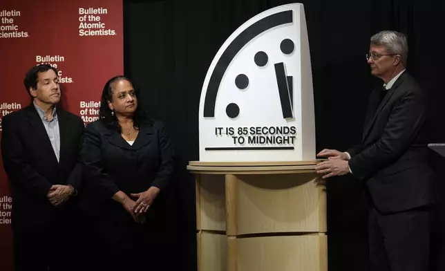 The Bulletin of the Atomic Scientists members, from left, Jon B. Wolfsthal, Asha M. George and Steve Fetter reveal the Doomsday Clock, set to 85 seconds to midnight, during a news conference at the Carnegie Endowment for International Peace, Friday, Jan. 23, 2026, in Washington. (AP Photo/Pablo Martinez Monsivais)
