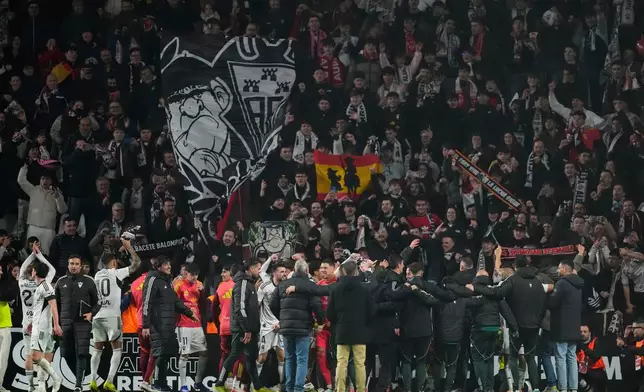 Albacete's players celebrate their team victory at the end the Copa del Rey round of 16 soccer match between Albacete and Real Madrid, in Albacete, Spain, Wednesday, Jan. 14, 2026. (AP Photo/Jose Breton)