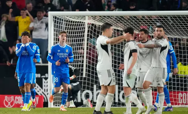 Real Madrid players react after Albacete scored its second goal during the Copa del Rey round of 16 soccer match between Albacete and Real Madrid, in Albacete, Spain, Wednesday, Jan. 14, 2026. (AP Photo/Jose Breton)