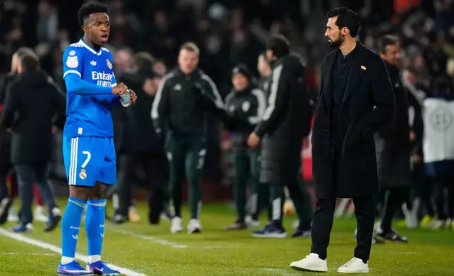 Real Madrid's Vinicius Junior, left, and Real Madrid's head coach Alvaro Arbeloa during the Copa del Rey round of 16 soccer match between Albacete and Real Madrid, in Albacete, Spain, Wednesday, Jan. 14, 2026. (AP Photo/Jose Breton)