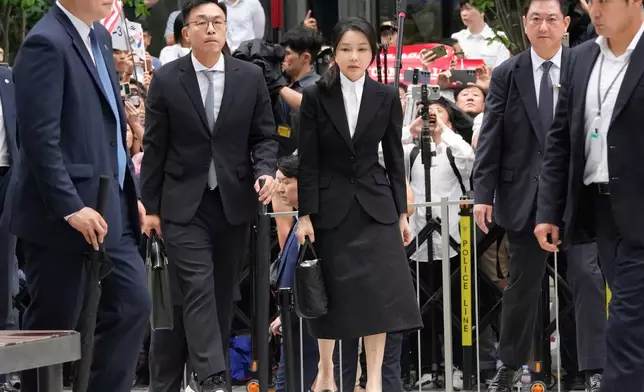 FILE - Kim Keon Hee, center, the wife of South Korea's ousted former President Yoon Suk Yeol, arrives at the special prosecutor's office in Seoul, South Korea, Aug. 6, 2025. (AP Photo/Ahn Young-joon, File)