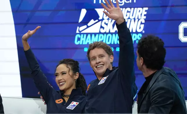 Madison Chock and Evan Bates watch the results after competing during the ice dance competition at the U.S. Figure Skating Championships, Thursday, Jan. 8, 2026, in St. Louis. (AP Photo/Stephanie Scarbrough)