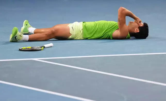 Carlos Alcaraz of Spain celebrates after defeating Alexander Zverev of Germany in their semifinal match at the Australian Open tennis championship in Melbourne, Australia, Friday, Jan. 30, 2026. (AP Photo/Dita Alangakra)