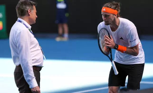 Alexander Zverev of Germany gesturers to a tournament official during his semifinal match against Carlos Alcaraz of Spain at the Australian Open tennis championship in Melbourne, Australia, Friday, Jan. 30, 2026. (AP Photo/Asanka Brendon Ratnayake)