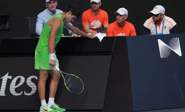 Carlos Alcaraz of Spain talks to his team during his semifinal match against o Alexander Zverev of Germany at the Australian Open tennis championship in Melbourne, Australia, Friday, Jan. 30, 2026. (AP Photo/Asanka Brendon Ratnayake)