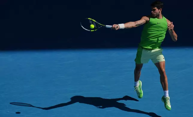 Carlos Alcaraz of Spain plays a forehand return to Tommy Paul of the U.S.during their fourth round match at the Australian Open tennis championship in Melbourne, Australia, Sunday, Jan. 25, 2026. (AP Photo/Dar Yasin)