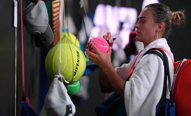 Aryna Sabalenka of Belarus signs autographs after defeating to Iva Jovic of the U.S. in their quarterfinal match at the Australian Open tennis championship in Melbourne, Australia, Tuesday, Jan. 27, 2026. (AP Photo/Dita Alangkara)