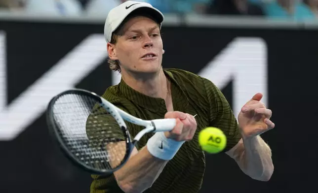 Jannik Sinner of Italy plays a forehand return to his compatriot Luciano Darderi during their fourth round match at the Australian Open tennis championship in Melbourne, Australia, Monday, Jan. 26, 2026. (AP Photo/Dar Yasin)