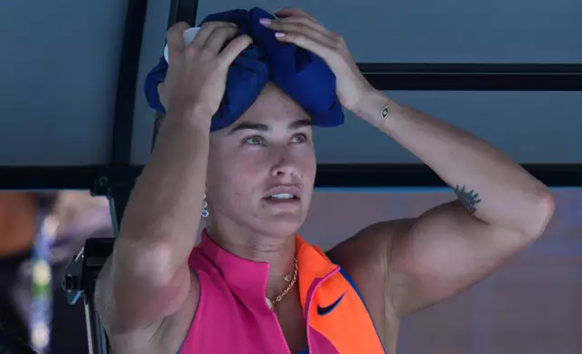 Aryna Sabalenka of Belarus places an ice pack to her head during her quarterfinal match against Iva Jovic of the U.S. during their quarterfinal match at the Australian Open tennis championship in Melbourne, Australia, Tuesday, Jan. 27, 2026. (AP Photo/Aaron Favila)