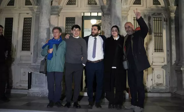 Rescue volunteers and their lawyer celebrate outside a courthouse in Mytilene, on the northeastern Aegean island of Lesbos, Greece, Thursday, Jan. 15, 2026, after being acquitted of charges related to aiding migrants. (AP Photo/Panagiotis Balaskas)